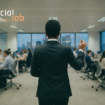 A minimalistic, back-view photograph of a corporate leader in a black suit holding a conductor's baton, standing before a modern, glass-walled enterprise office where employees work at rows of desks. SocialLab logo at the left corner.